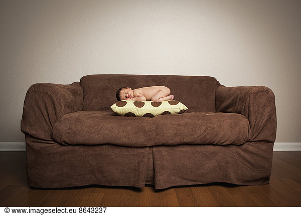 A Naked Newborn Baby Lying On His Front A Naked Newborn Baby Lying On