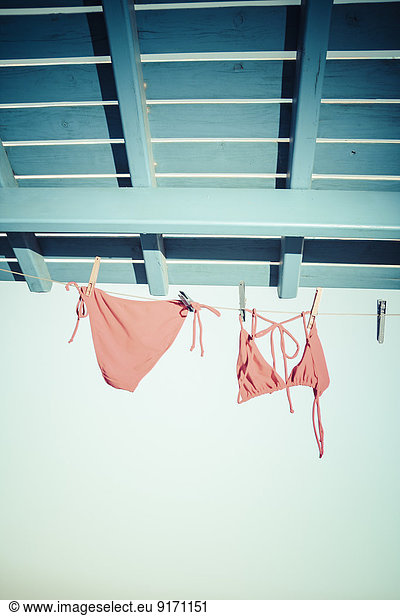 Bikini Hanging On Clothes Line Under The Roof Bikini Hanging On Clothes