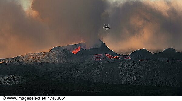 Helicopter Flying Over Erupting Volcano With Lava Fountains And Lava