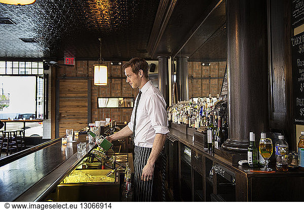 Side View Bartender Pouring Drink Side View Bartender Pouring Drink