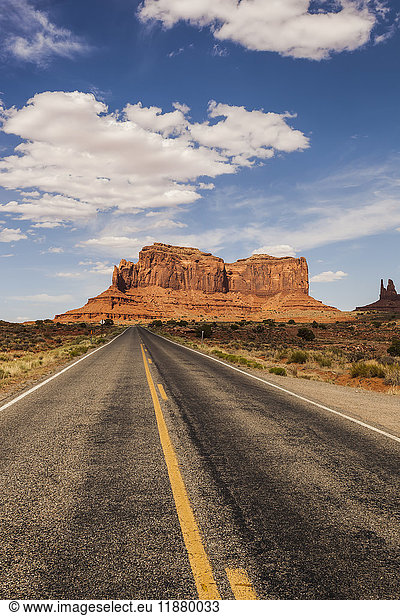'A road leading to a rugged rock formation in the desert; Arizona  United States of America'