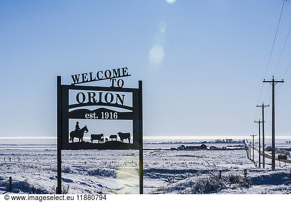 'A sign saying welcome to Orion with snow covered fields in the background; Orion  Alberta  Canada'