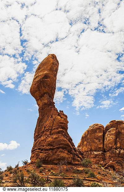 'A tall  rugged rock formation in a desert landscape  Arches National Park; Utah  United States of America'