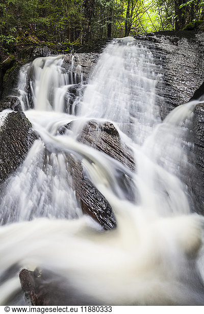 'A waterfall splashing down a rocky embankment in a forest; Middle Sackville  Nova Scotia  Canada'