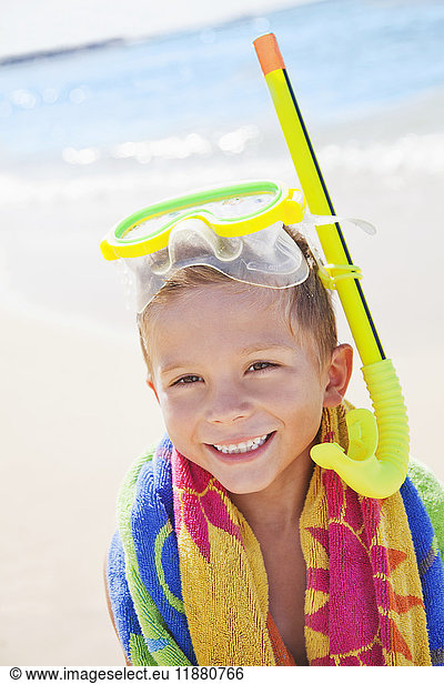 'A young boy smiling with snorkel gear at the beach; Honolulu  Oahu  Hawaii  United States of America'