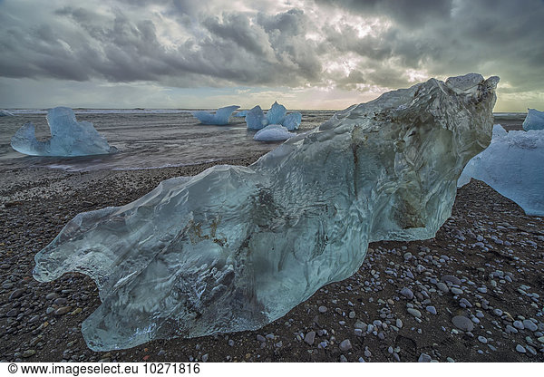 'Along the south shore of Iceland  large chunks of ice litter the beach after being washed out to sea from the Jokulsarlon lagoon; Iceland'