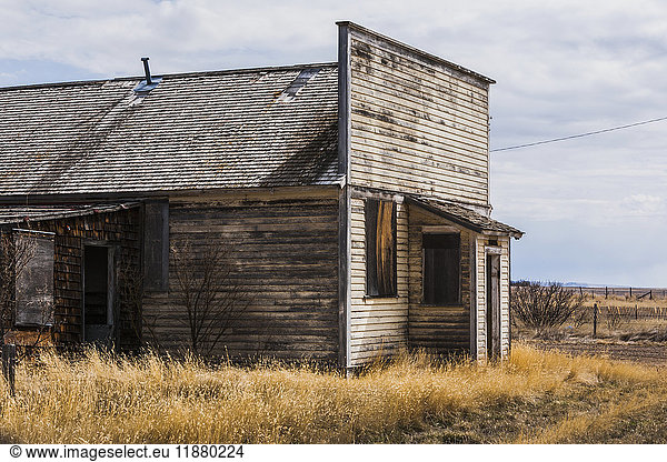 'An old  abandoned wooden building on the prairies; Orion  Alberta  Canada'