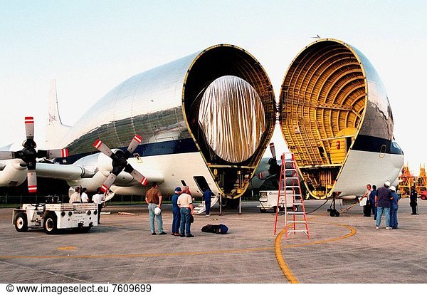 11/17/1999 __ At Kennedy Space Center´s Shuttle Landing Facility  workers watch as the nose of NASA´s Super Guppy aircraft opens to reveal its cargo  a component for the International Space Station ISS  the port_side P3 truss. The truss is scheduled to be added to the ISS on mission STS_115 in 2002 aboard Space Shuttle Atlantis. The second port truss segment  P3 will be attached to the first port truss segment P1. The P3 truss will be taken to the Operations and Checkout Building
