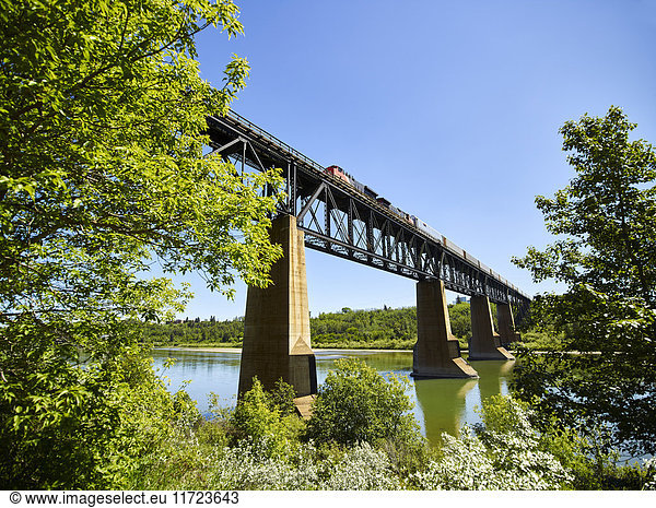 'Bridge with a train crossing the North Saskatchewan River; Edmonton  Alberta  Canada'