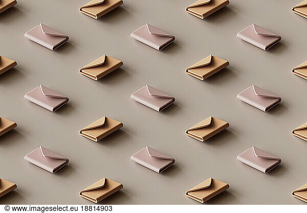 3D pattern of rows of e-mail icons lying against brown background
