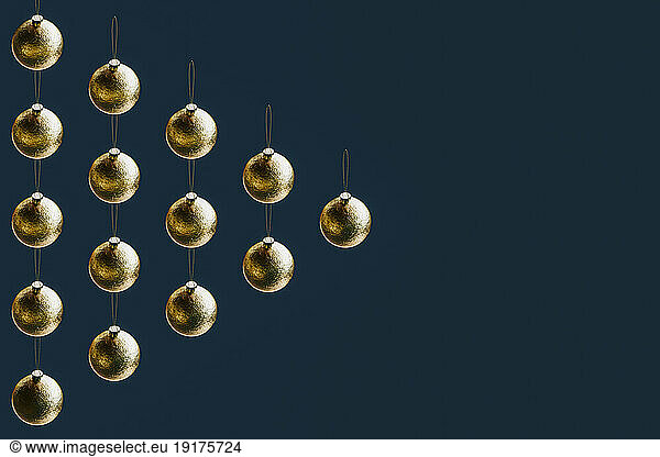 3D render of gold-colored Christmas ornaments forming triangle