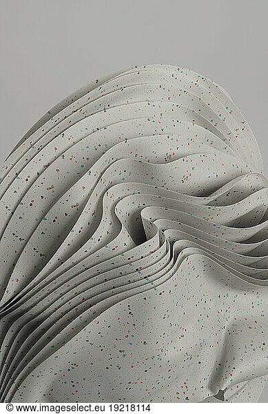 3D render of layers of white spotted material
