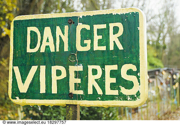 'Danger vipers' sign at the edge of a small stream and allotments  Allier  Auvergne  France