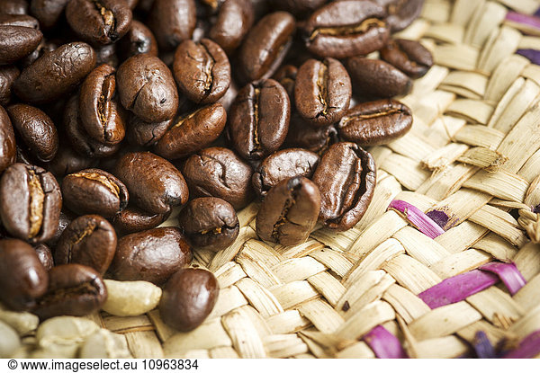 'Detail of roasted Ethiopian coffee beans on woven straw plate; Takoma Park  Maryland  United States of America'