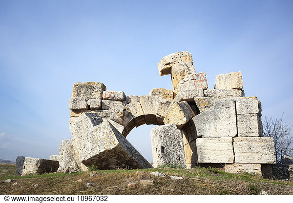 'Fallen wall and stone block in front of an arched doorway; Laodicea  Turkey'