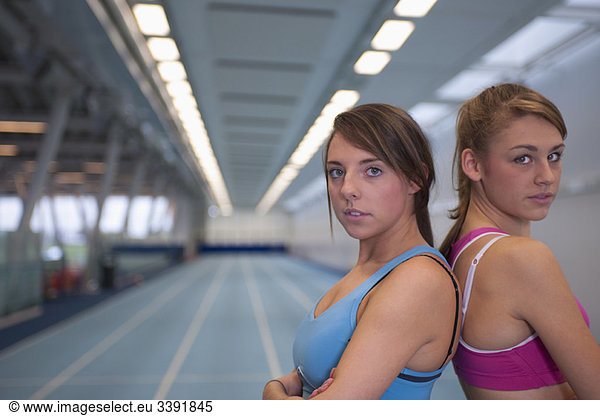 2 female athletes looking to camera