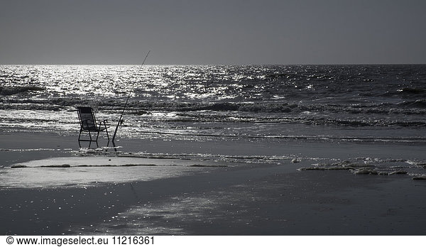 'Fishing pole on an empty chair; Hilton Head Island  South Carolina  United States of America'