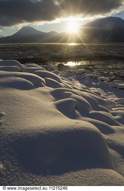 'Fresh snow  rising sun and Turnagain Arm in winter  near Girdwood  South-central Alaska; Alaska  United States of America'