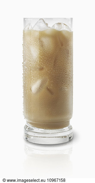 'Glass of a light brown coloured beverage with ice cubes on a white background; Toronto  Ontario  Canada'