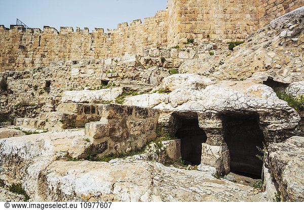 'Historic ruins with a large wall and cave; Jerusalem,  Israel'
