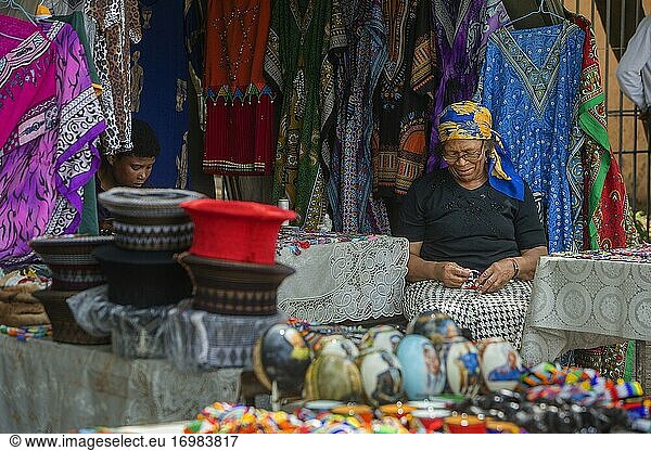 Ältere afrikanische Frau macht ein Armband auf einem Markt in Soweto Township  Südafrika
