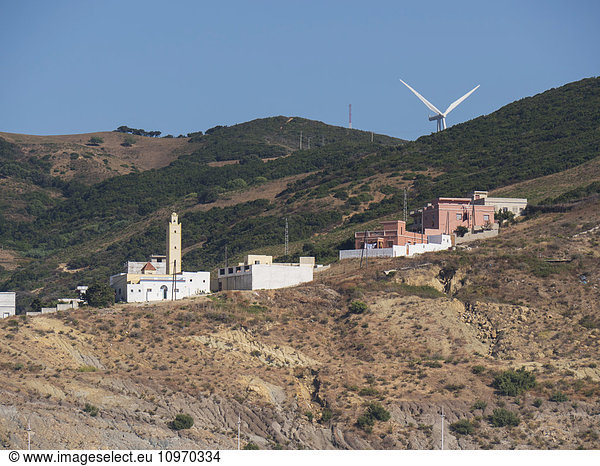 'Mosque and wind turbine on the hillside above the Mediterranean port; Tangier  Morocco'