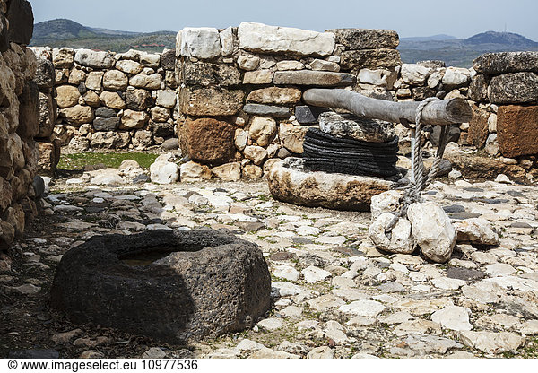 'Olive press and stone basin at the site of ancient ruins; Tel Hazor  Israel'