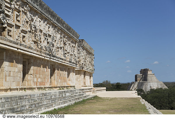 'Palace of the Governor (left)  House of the Magician (background  right)  Uxmal Mayan Archaeological site; Yucatan  Mexico'