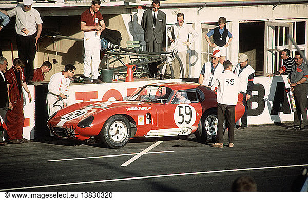 'Peter Sutcliffe-Peter Harper´s Shelby Cobra Daytone Coupe  red and white in Switzerland´s honour by Swiss Scuderia Filipinetti. Le Mans  France  20 June 1965. '