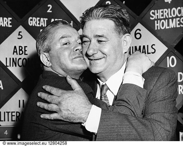$64 000 QUESTION  1956. Gino Prato  left  and Michael Della Rocca  both Italian-born shoemakers  embracing after together having won $64 000 for their knowledge of opera in the CBS-TV quiz show 'The $64 000 Question ' February 1956.