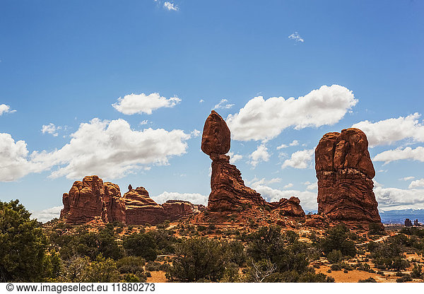 'Rugged rock formations and shrubs in the desert  Arches National Park; Arizona  United States of America'