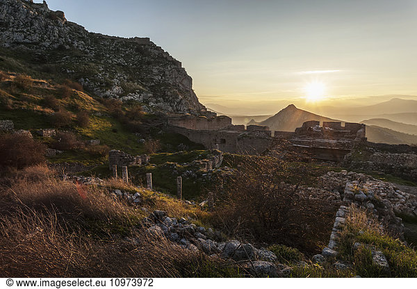 'Ruins of stone buildings and walls at sunset; Corinth  Greece'