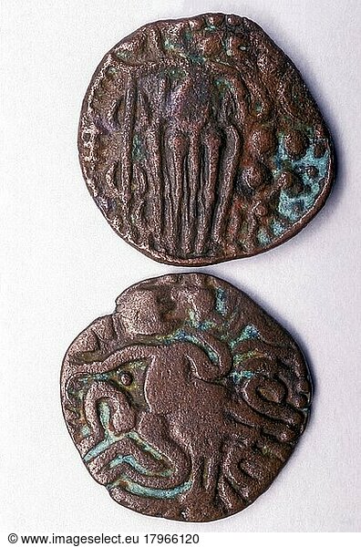 10th century Chola copper coin  Rajaraja kasu  top Standing man with lamp on left and group of pellets on right  bottom Coin half seated with raised arm on right devanagiri legend beneath raised arm 'Sri Rajaraja'