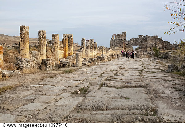 'Tourist walking along the ruins of an ancient street; Pamukkale  Turkey'