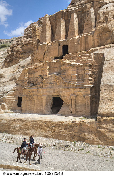 'Tourists on horses  Obelisk Tomb (upper structure)  Bab as-Sig Triclinium (lower Structure); Petra  Jordan'