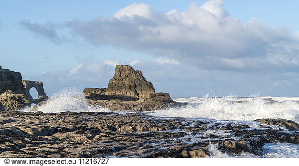 'Waves splashing onto the rock formations on the coast; South Shields  Tyne and Wear  England'