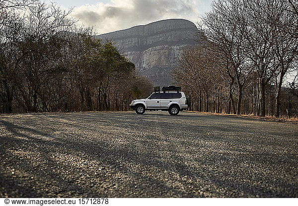 4x4 parked on a country road with a mountain in background  Limpopo  South Africa