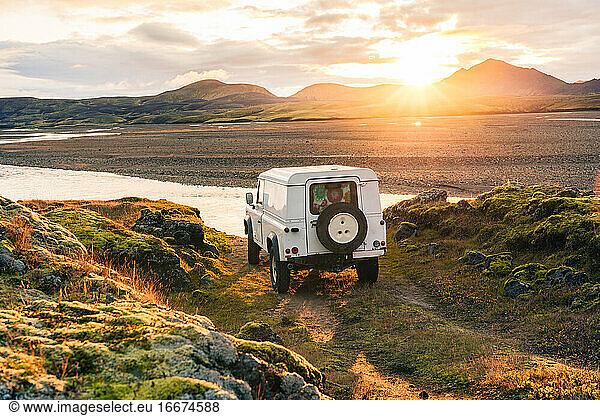 4x4 Truck looks out over sunrise landscape in Iceland