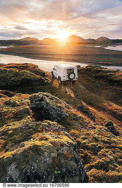 4x4 Truck looks out over sunrise landscape in Iceland