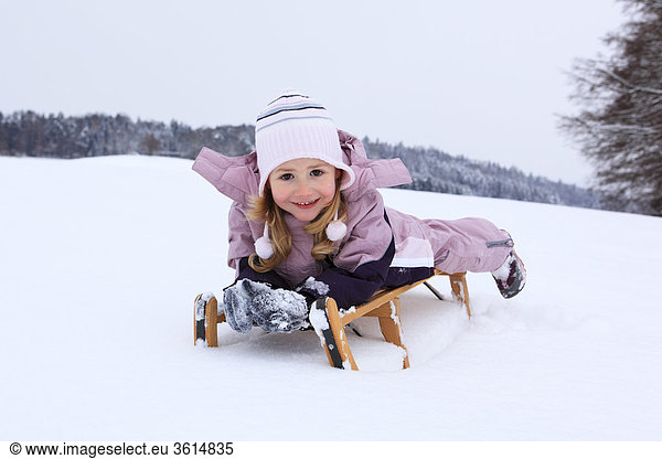 3 3-year-old activity belly ice joy luck happiness hair gloves wood wooden sledge years cap knee runner cold scenery girl cap hat portrait sledge sledge sleigh snow snowy suit Switzerland fun joke play game sports device means of transportation pleasure wood forest winter winter scenery actively belly blond directly immediately outdoors outside fun happily young cold small kneel chilly laugh joke long hair lie outdoor pink toboggan pink Swiss sit play snow-covered snowy white