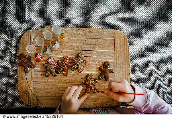 4 year old girl paints chocolate gingerbread men