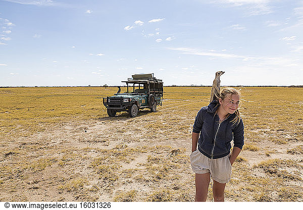 12 year old girl with Meerkat on her head  Kalahari Desert