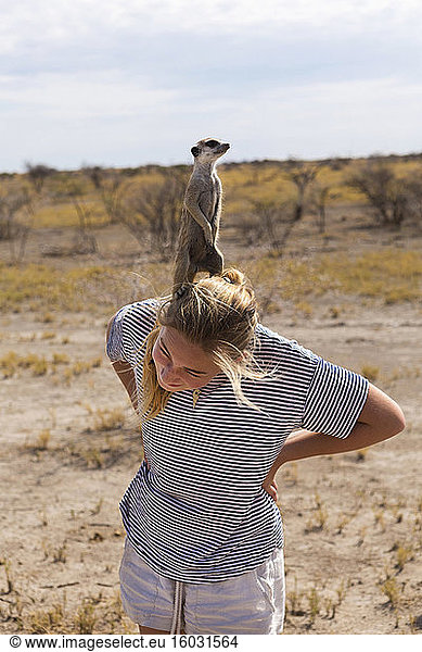 12 year old girl with Meerkat on her head  Kalahari Desert  Makgadikgadi Salt Pans  Botswana