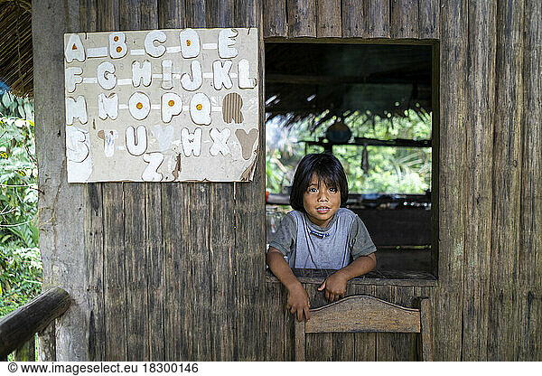 4-year-old Rama child at the kitchen window and alphabet on the wall  house along the Rio Indio river  Nicaragua  San Juan de Nicaragua