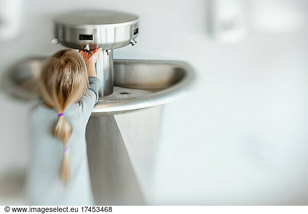 5 years old girl washing her hand in pandemic time