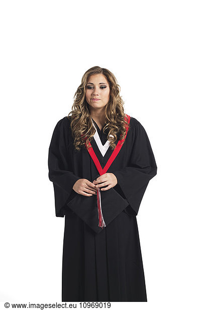'Young graduating woman holding her graduation cap and contemplating her graduation; Edmonton  Alberta  Canada'