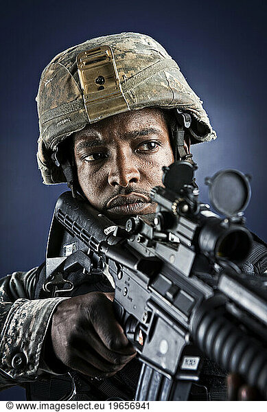 A African American  male  Air Force Security Forces Airman in uniform poses with his M-4 rifle.