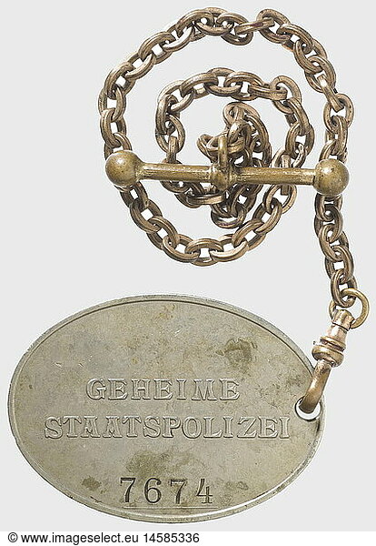 A badge '7674' of the GESTAPO.  Nickel-silver  raised national eagle and the inscription 'GEHEIME STAATSPOLIZEI' (Secret State Police) in the typical caption  above the stamped number '7674'. Dimensions 37 x 51 mm. On a non-ferrous metal chain with snap hook and buttonhole toggle  also remnants of gilding. In addition an expertise of authenticity by Don Bible  September 2008. Of utmost rareness. historic  historical  1930s  1930s  20th century  medal  decoration  medals  decorations  honouring  honor  honour  honors  honours  badge  badges  object  objects  stills  clipping  clippings  cut out  cut-out  cut-outs