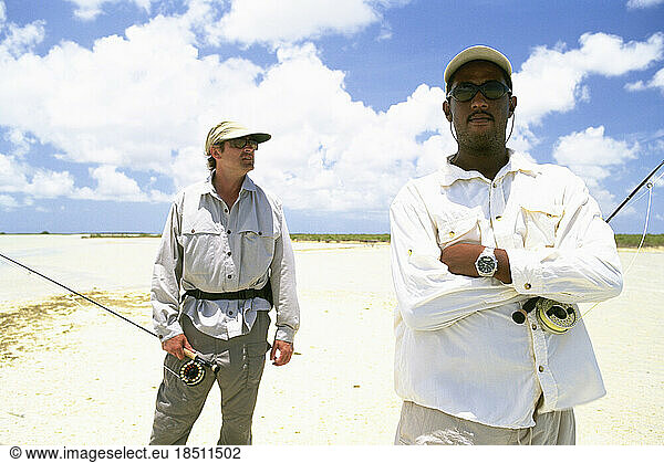 A Bahamian guide and his client search for fish in the Bahamas.