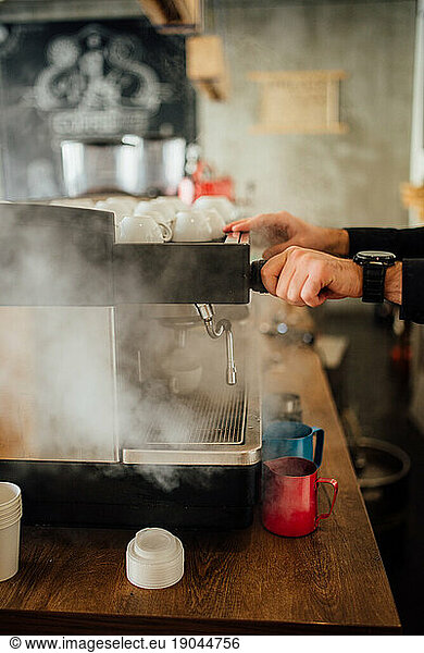 A barista making coffee at an espresso machine